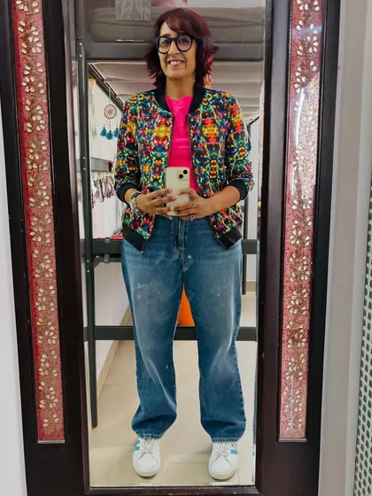 My comfy and casual office cricket match outfit: a bright crop top, my favorite jacket, and baggy jeans.