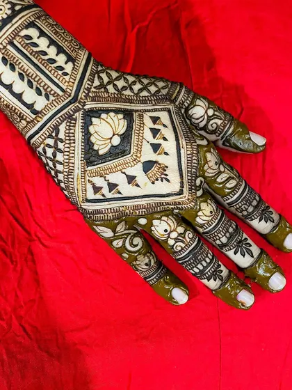 I love playing with modern design concepts like this negative space mehendi. The un-inked skin becomes part of the art, creating a bold and contemporary look centered around a lotus motif.