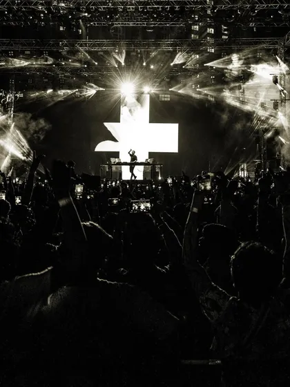Another artistic black and white photo, focusing on the scale of the crowd and the stage.
