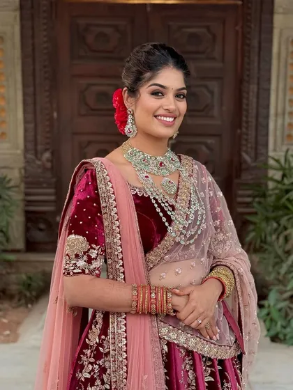 A radiant smile for a joyous Sangeet night. This look features glowing skin and defined kohl eyes, paired with a modern messy updo, creating a perfect blend of royal grace and contemporary magic.