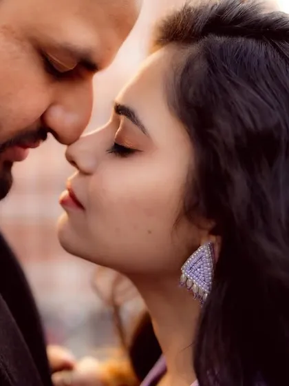 A beautiful, soft-focus close-up of a couple about to kiss. This intimate shot captures the quiet moments of affection that happen just before a big gesture.