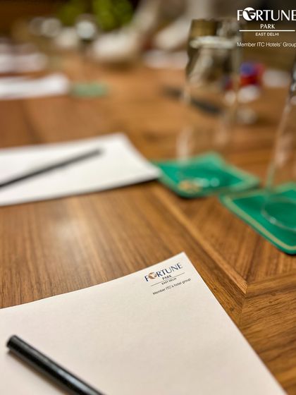 A close-up of the branded notepad and pen provided at every seat in my boardroom. This attention to detail reflects my commitment to delivering a premium and seamless experience for all corporate events.