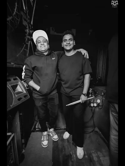 A black and white shot capturing the partnership behind the music. We bring a blend of modern DJing and traditional percussion to create a sound that's both fresh and timeless.