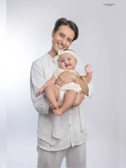 A father's love is a special thing. This classic, simple studio portrait beautifully captures the tender bond between a dad and his baby girl.