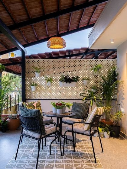 A view of the Mathrukrupa terrace, designed as a functional and beautiful outdoor living space with ample room for plants and seating.