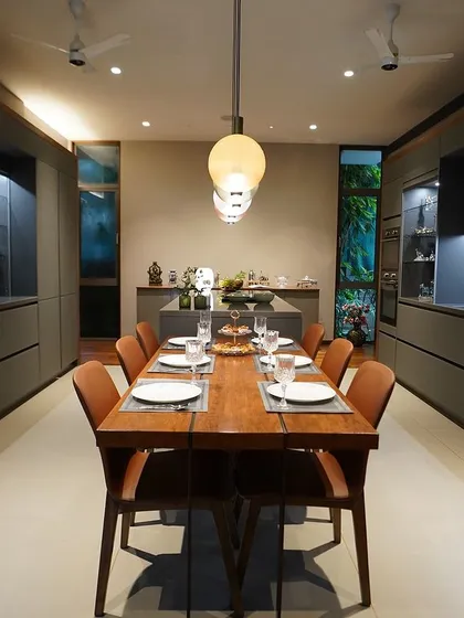A symmetrical view of the Paul family's kitchen, showcasing the clean lines and balanced proportions. The glass display cabinets on either side add lightness and a place for treasured items.