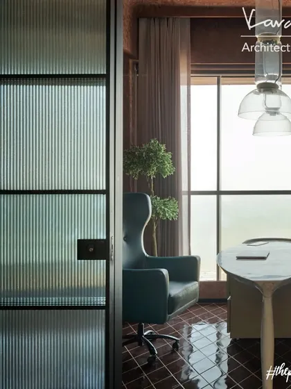 A view into the office den through a reeded glass partition. The partition provides privacy while still allowing light to filter through, maintaining a sense of openness.