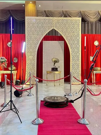 My setup against a traditional, ornate backdrop for a wedding event. I work with your event planner and decor team to ensure the booth area complements the overall theme, complete with a red carpet and velvet ropes.