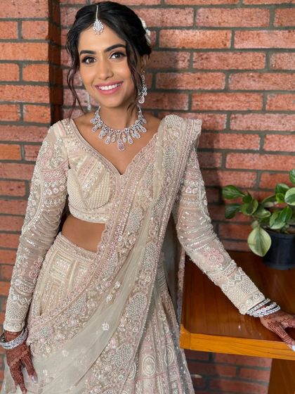 The complete reception look, showing how the soft makeup complements the intricate, shimmering lehenga.