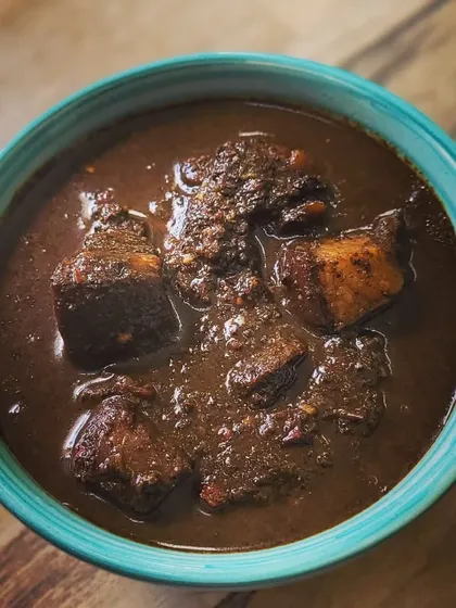 A close look at my Anishi with Pork, a signature dish from the Ao Naga tribe. It's a rich, smoky curry made with fermented taro leaves and tender pork, a flavour you won't find anywhere else.