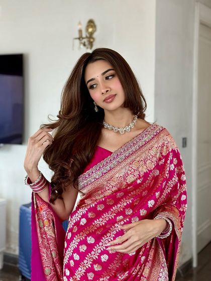 This pose highlights the voluminous, soft curls and the elegant diamond necklace, all part of a cohesive and regal engagement look.