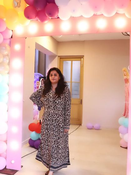 Our event planner standing proudly at the entrance of a beautifully decorated party venue.