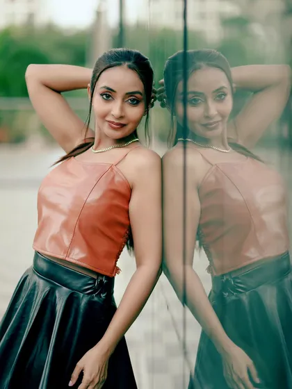 A full-length shot showing the complete outfit and the model's reflection, creating a visually interesting composition.