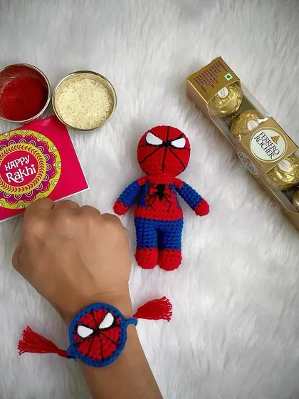 A Spider-Man Rakhi hamper! This set comes with a Spider-Man themed Rakhi and a matching mini Spider-Man doll, a perfect gift for a little superhero fan.