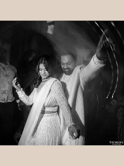 A motion-blur black and white shot of the couple dancing, capturing the energy and movement of the moment.