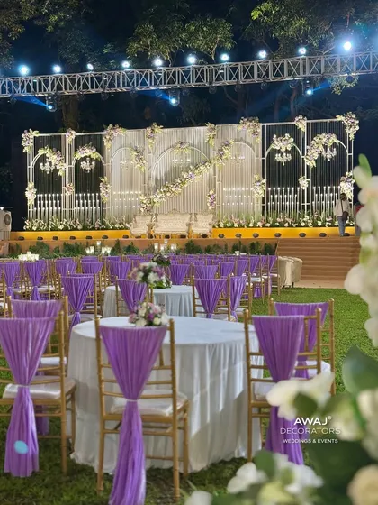 The elegant guest seating arrangement with lavender drapes, perfectly complementing the sophisticated stage design for a cohesive and beautiful event space.