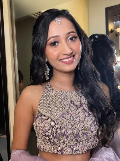The final result of this beautiful engagement makeup. Her skin is radiant, and the soft purple tones on her eyes complement her intricate halter-neck blouse.