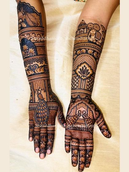 A grand bridal design featuring elephants, swans, and peacocks. The details are sharp and clear, from the lotus flowers on the fingers to the palace dome at the top.