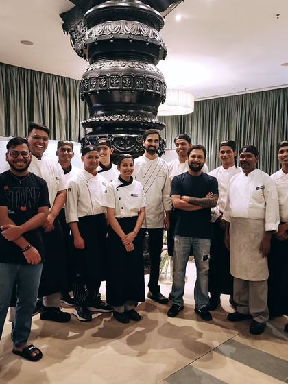 The full culinary team poses with Chef Aal in our lobby. These collaborations are an amazing experience for our entire staff, fostering growth and synergy.