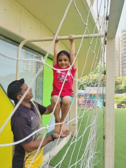 This young camper beams with pride while practicing on the gymnastics equipment. These moments of achievement are what make our summer program a truly rewarding experience for children.