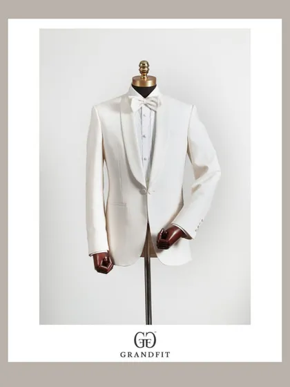 Beyond traditional wear, we craft exquisite formal ensembles. This classic white tuxedo, featuring a shawl collar and made-to-measure construction, is the pinnacle of reception and black-tie elegance.