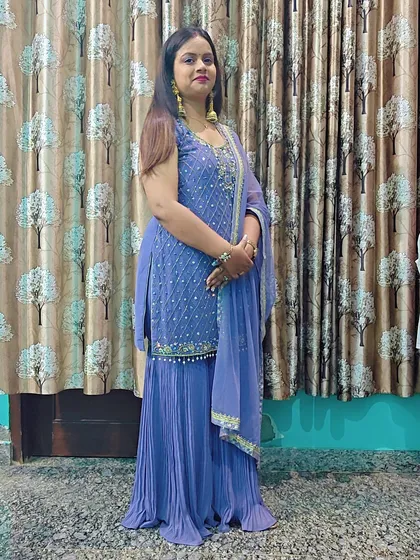 A beautiful periwinkle blue sharara set. The kurta is detailed with delicate embroidery, and the pleated sharara pants add a touch of modern flair.