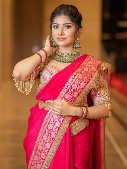A confident pose showcasing the full traditional look. The makeup is designed to complement the heritage couture, making her look and feel like a queen.