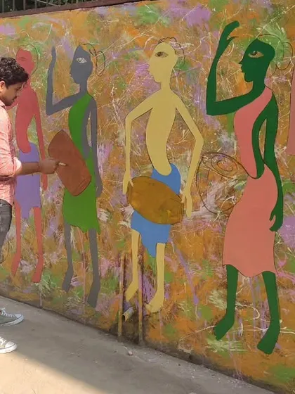 The process of adding color to the large folk art wall mural, bringing the figures of the musicians to life.