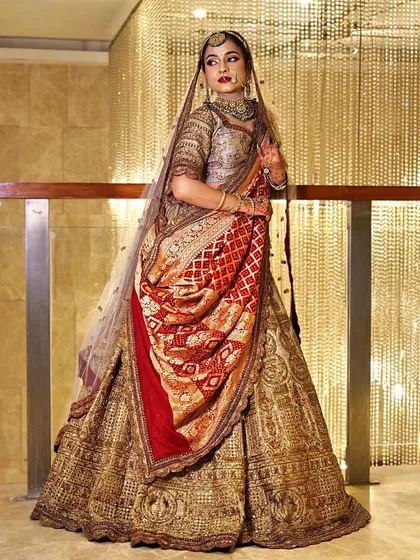 A full-length view of this stunning bride. The combination of a pastel lehenga and a traditional dupatta is a perfect example of modern Indian bridal style.