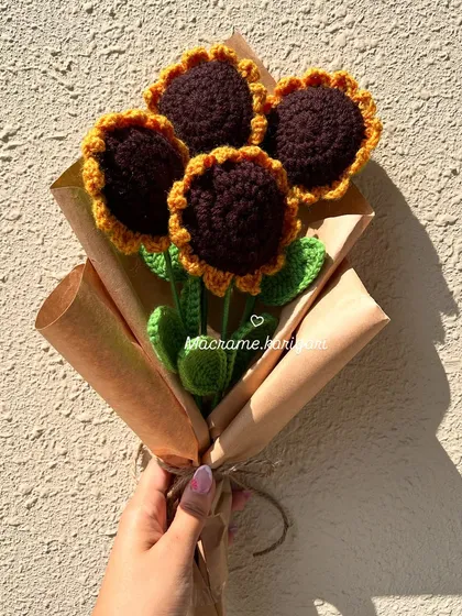 A beautiful handmade crochet sunflower bouquet, wrapped in rustic brown paper. This makes for a thoughtful and sustainable gift that brings lasting joy.