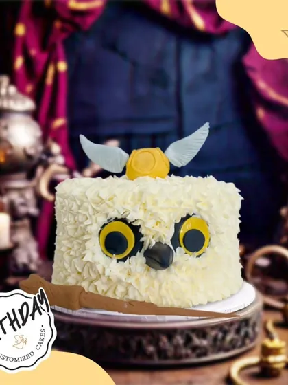 A magical Harry Potter owl cake, complete with a wand and a golden snitch. This whimsical design is perfect for any Potterhead's birthday.