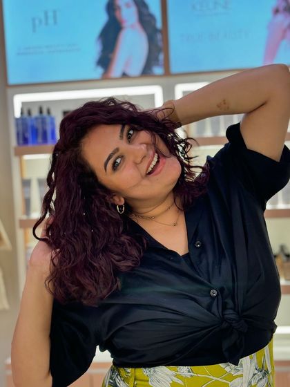 A new wine-red look for this curly-haired client. She is absolutely glowing with her fresh color and defined curls.