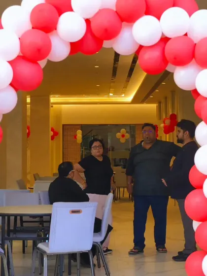 Guests mingling at the 5th-anniversary party. Our entrance arches create a wonderful first impression and a great photo spot for arriving guests.