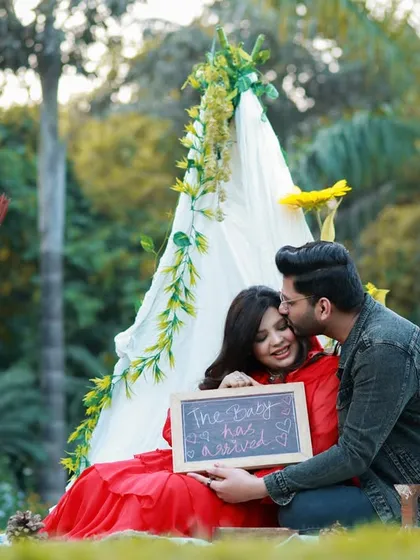 A candid moment from an outdoor couple's maternity shoot. We set up a cozy teepee picnic scene, and this sweet kiss captures the genuine joy and anticipation of their journey together.