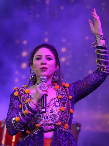 A powerful pose on stage, ready to engage with the thousands of people in the audience.