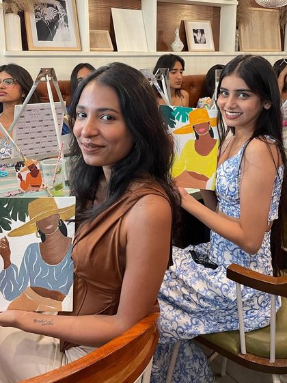 Two friends enjoying a painting session together at a cafe. It's a great way to catch up while doing something creative.