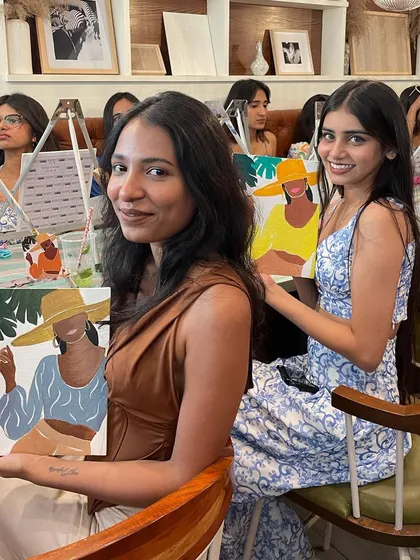 Two friends enjoying a painting session together at a cafe. It's a great way to catch up while doing something creative.