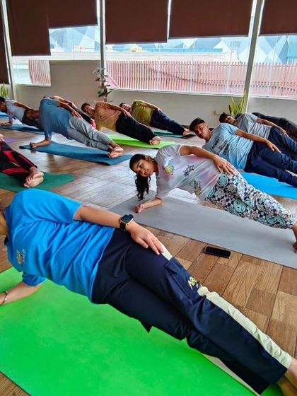 "Never Give Up!" is the spirit in our studio. Here, students hold a challenging side plank, supporting each other with their collective energy and determination.