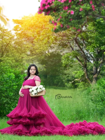 A stunning solo portrait in a wine-colored ruffled gown. The long train and the beautiful garden create a magical image.