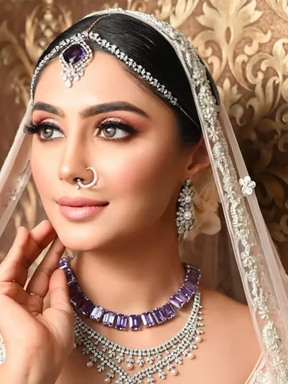 The same sleek bun, shown with a veil. This hairstyle is perfect for supporting a dupatta while maintaining a clean and elegant silhouette.