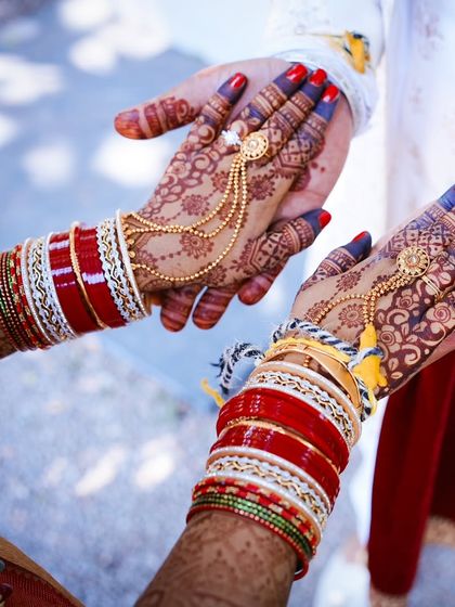 A beautiful couple shot, where the bride's dark henna stain is a prominent and beautiful feature.