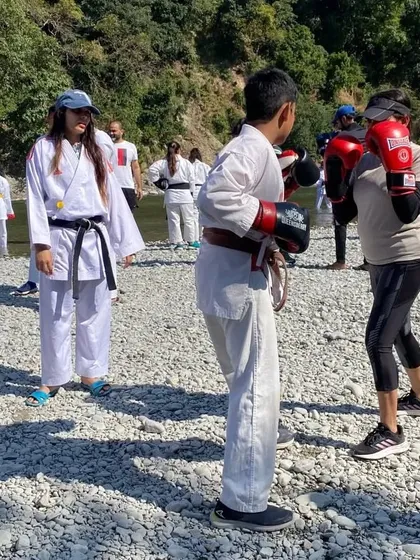An outdoor training session with students on a riverbank. Taking our practice into the elements helps build mental toughness and adaptability, key traits for any martial artist.