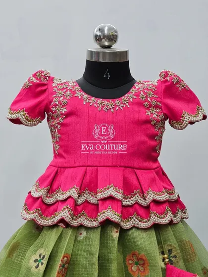 Another angle of the pink peplum blouse, highlighting the craftsmanship of the hand embroidery.