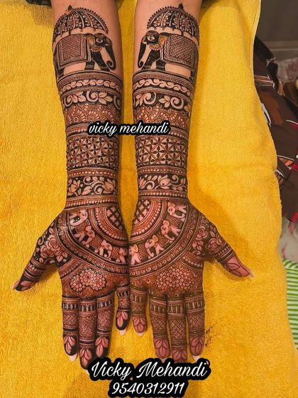 A beautiful example of a non-figurative bridal design. This piece focuses on intricate patterns, floral motifs, and a procession of elephants on the arms.