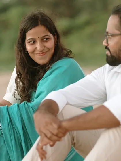 An intimate close-up of the couple sharing a moment on the beach, her loving gaze showing the deep connection they share.