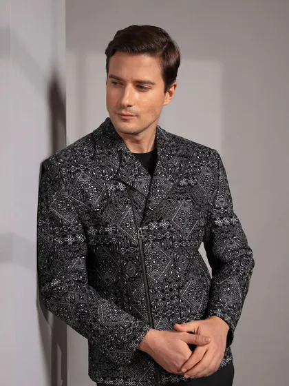 This black jacket features an intricate, all over geometric print and a modern zipper closure. It is a statement piece for the man who appreciates bold design.