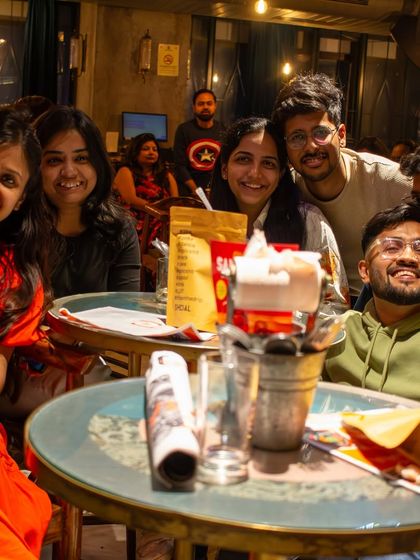 A table full of smiles. We love seeing groups of friends come together to share their love for Bollywood music and create new memories.
