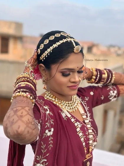 A candid moment of the bride adjusting her dupatta. The makeup remains flawless, showcasing its longevity and ability to look great from every angle.