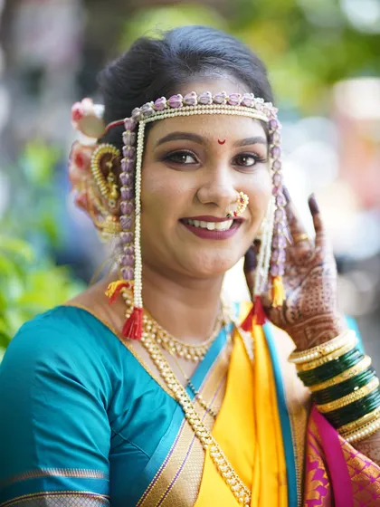A smiling close-up of the bride. This photo shows how the makeup enhances her features, giving her a confident and beautiful glow.
