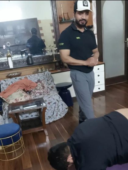 Observing my client's form closely during a floor exercise. My complete attention is on you during our sessions.